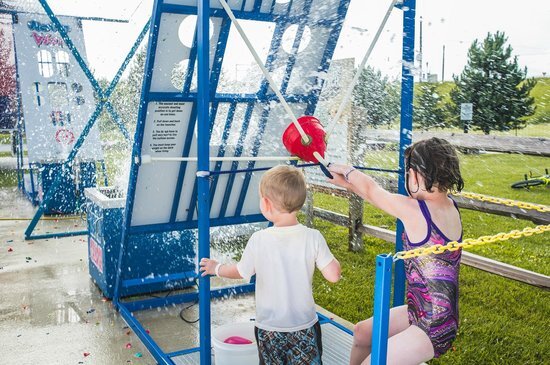 Water Wars action shot of girls getting blasted with water from Austin Bounce House Rentals
