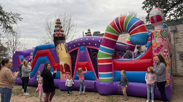 33' Sugar Shack Obstacle Course rental with kids playing outdoors from Austin Bounce House Rentals™
