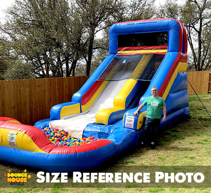 Man Standing Next to Slide'n Play with Ball Pit Rental item from Austin Bounce House Rentals in Austin Texas