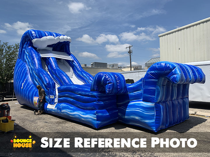 Man next to Wild Wave Water Slide rental in Austin Texas from Austin Bounce House Rentals