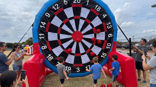 Kids playing Soccer Darts outdoors in Central Texas.