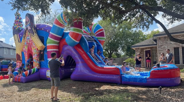Sugar Shack Combo setup in yard in Austin Texas with kids playing and parents snapping photos.