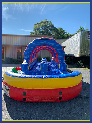 Front view of the slip and slide unique ruffle rings and a two lane slide with pool.