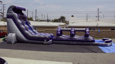 Side view of a 22 foot water slide attached with a slip n slide.