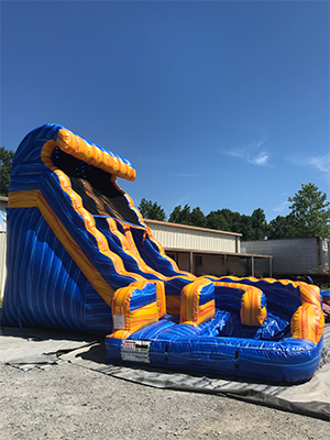 Side view of 18' foot water slide with a pool attached at the bottom of the slide.