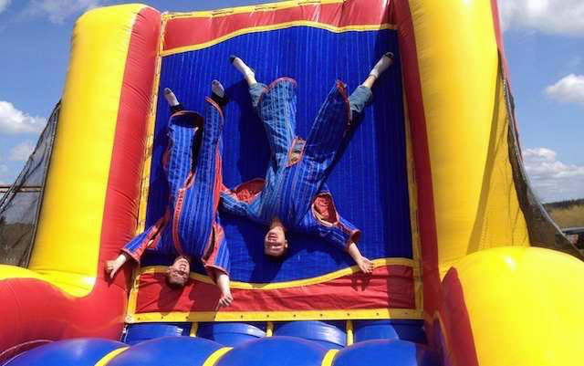 Kids stuck to the inflatable velcro wall