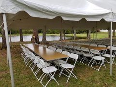 White 20 x 20 Pole Tent with Banquet Tables & White Chairs