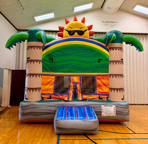Tropical Sun Bounce House Rental set up inside a school gym for a school field day