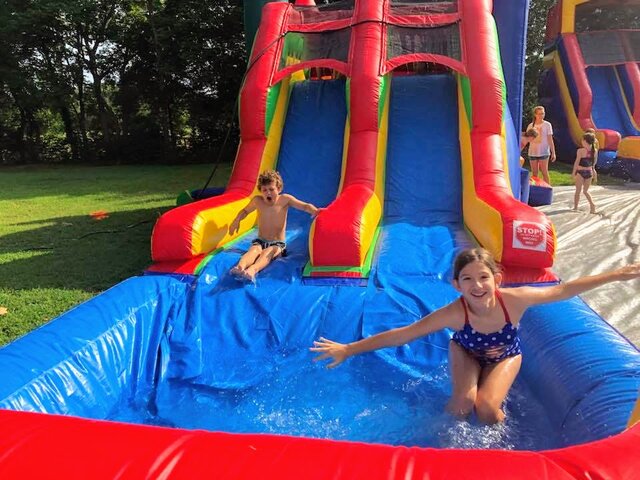Girls Playing on Bluey Bounce House Water Slide