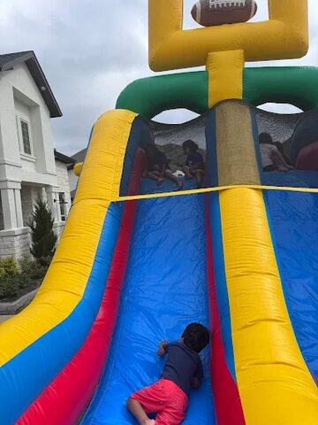 Sliding into fun like a pro! 🏈🌈 Who's ready for some bounce-tastic adventures?