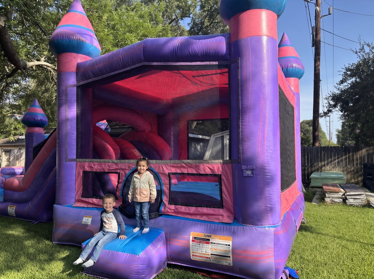 Kids on the steps of a Princess Palace combo in a Katy backyard