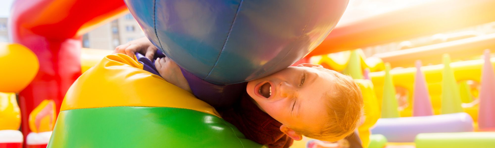 Kids racing through an inflatable obstacle course rental in Hendersonville, NC