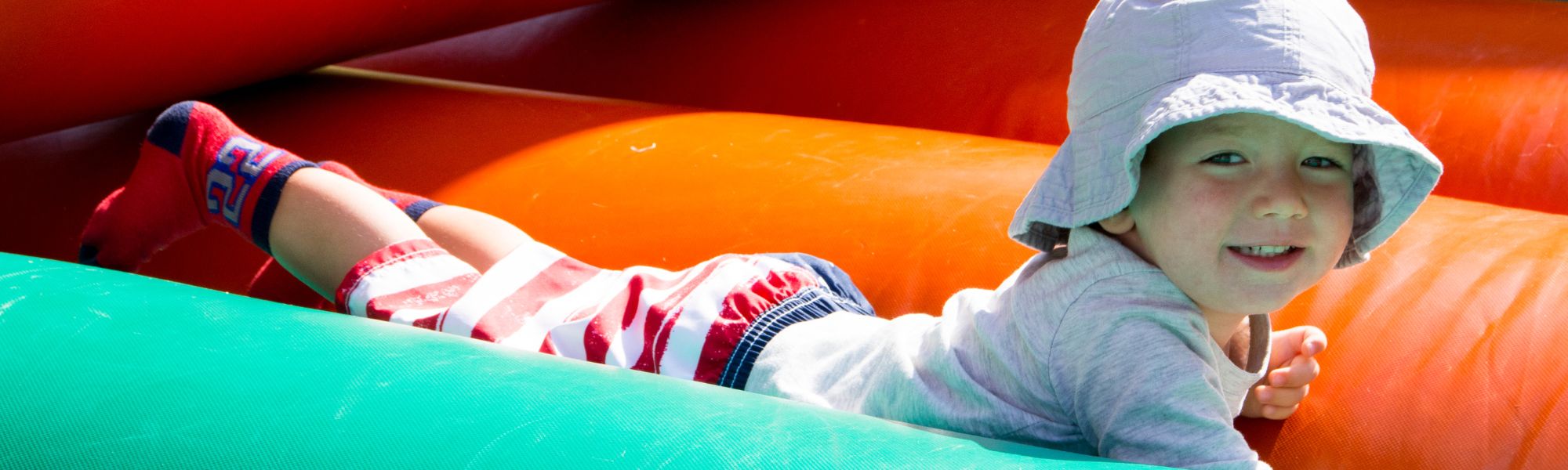 Kids playing on an inflatable water slide rental in Hendersonville, NC