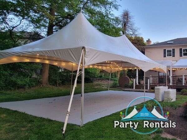 Classic pole tent adding charm to an outdoor wedding