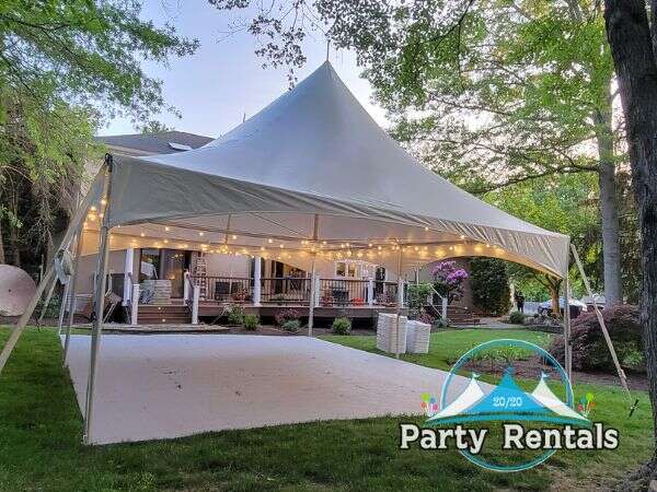 A cozy backyard party tent adorned with festive decorations and comfortable seating options.