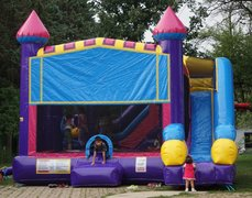 Bounce House rental near Wheaton Il. Inflatable bounce house with slide and basketball hoop.