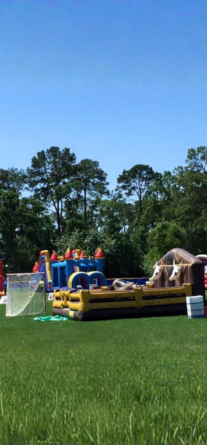 Events by ABA mechanical bull and bounce house rentals outdoors.