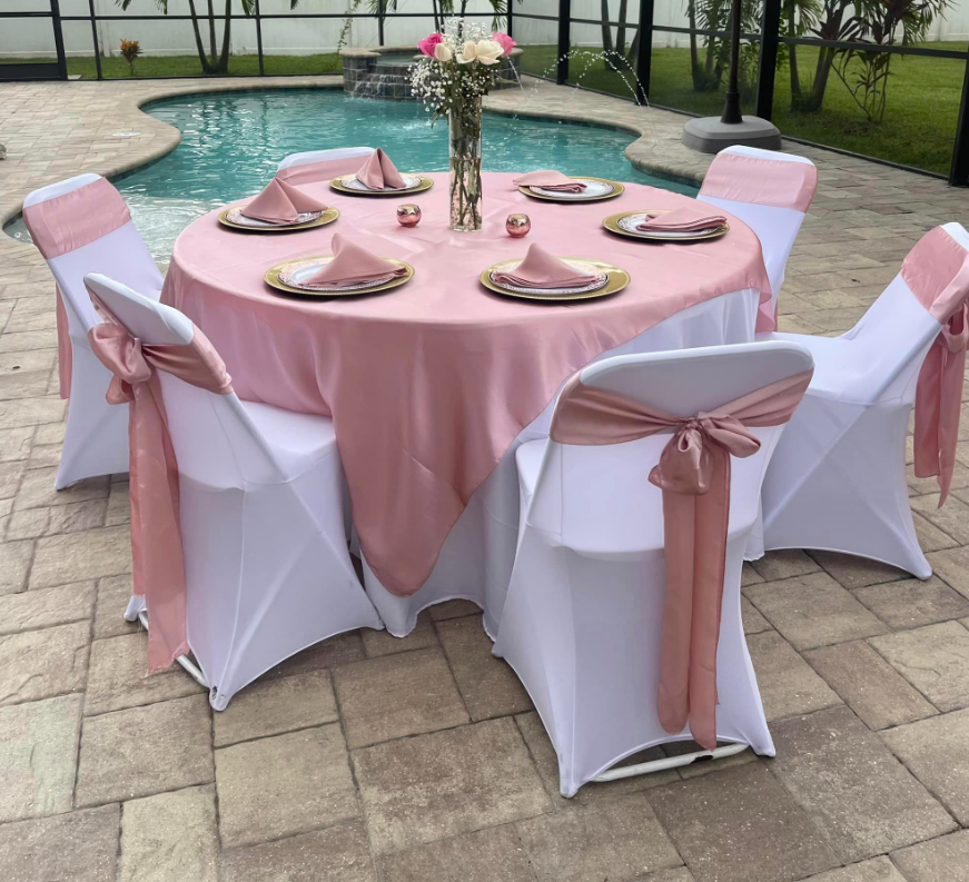 A variety of linen rentals displayed elegantly. The image showcases an assortment of high-quality linens available for rent, including tablecloths, napkins, and chair covers, perfect for events and special occasions. Explore our wide selection of linen rentals at A&B Party Rentals in Salisbury, MD
