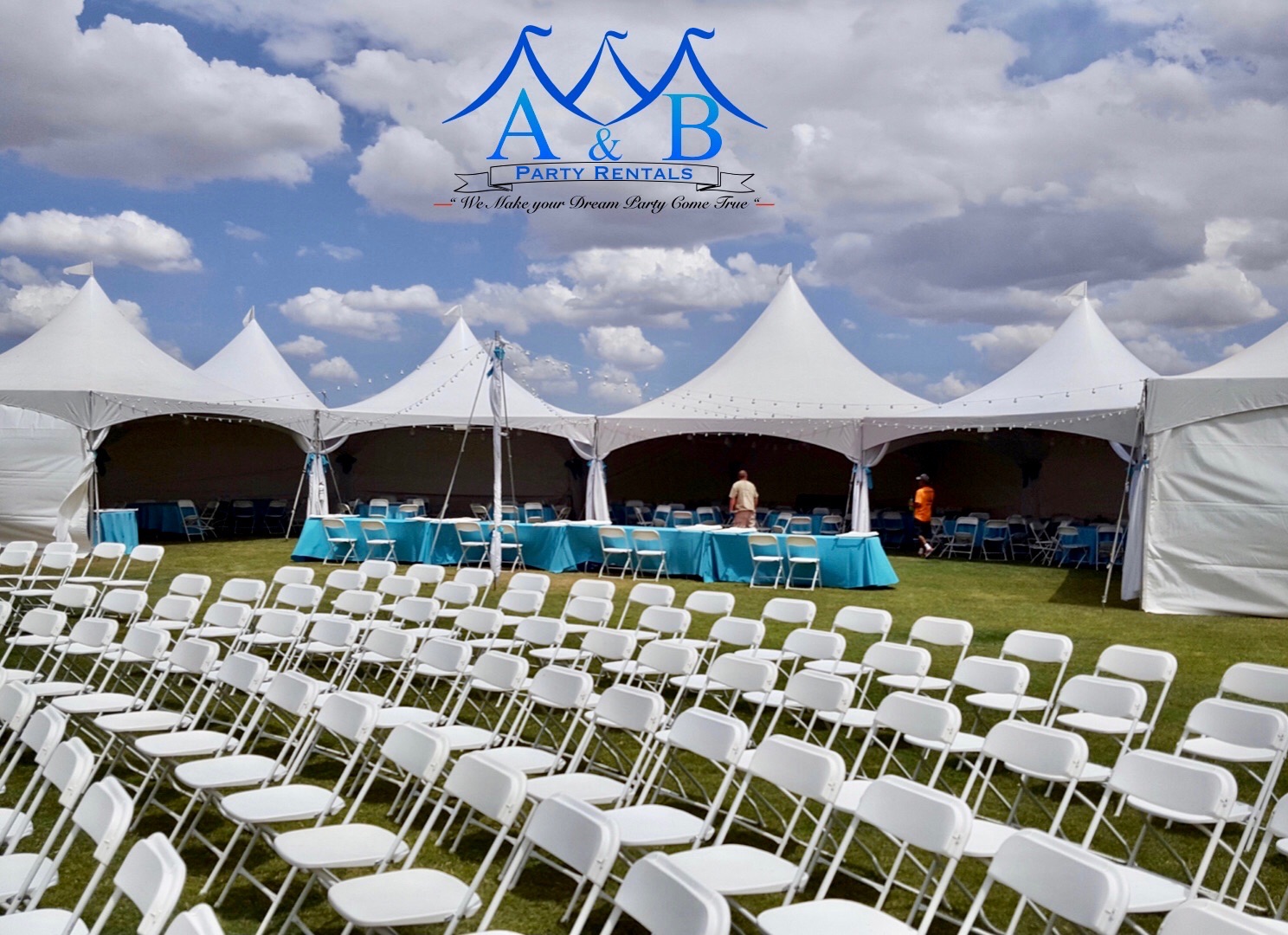 Elegant outdoor party setup by A&B Party Rentals featuring round tables with white linen, gold chiavari chairs, and a string of fairy lights twinkling against a twilight sky in Salisbury, MD