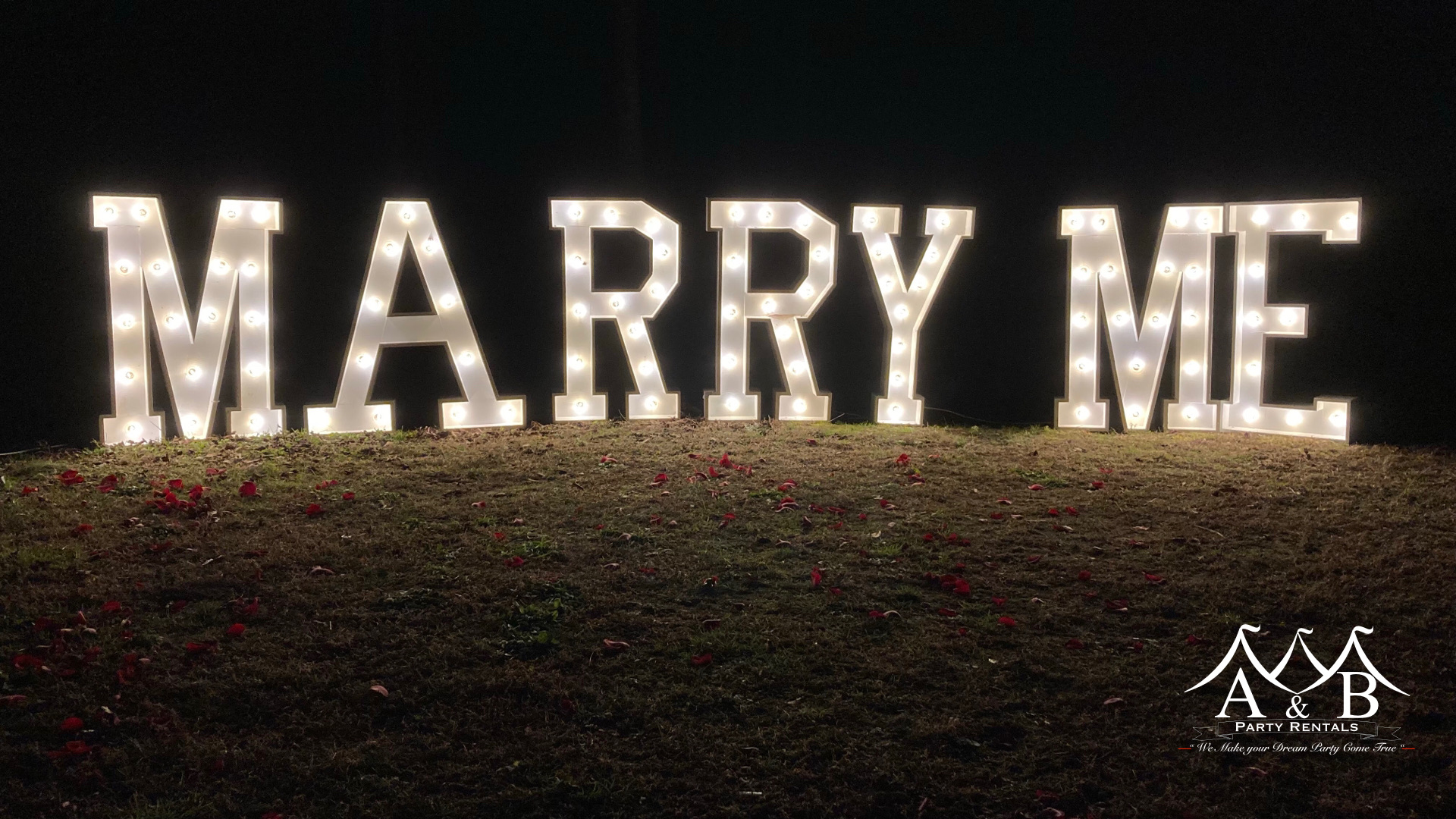 Large marquee letters that spell out 'Marry Me.' The image features illuminated marquee letters spelling 'Marry Me,' adding a romantic touch to events, available through A&B Party Rentals in Salisbury, MD.