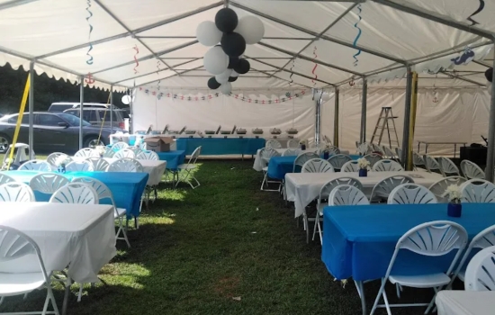 A&B Party Rentals tent setup with tables, chairs, and linens