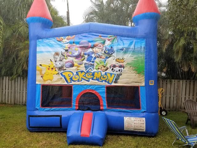 Blue castle bounce house with hoop in side