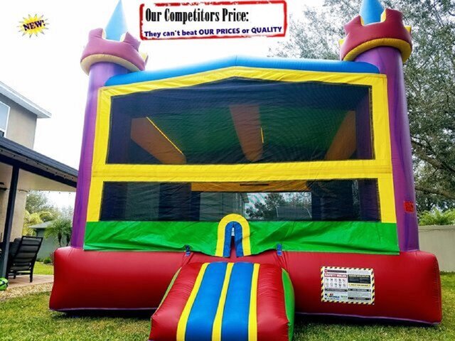 bounce house with slide and basketball hoop