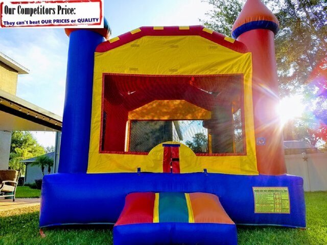 bounce house with slide and basketball hoop