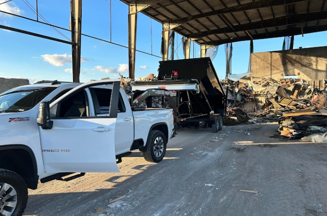 Truck from All Pro Dumpster Rental & Hauling, LLC working at a concrete and asphalt recycling site