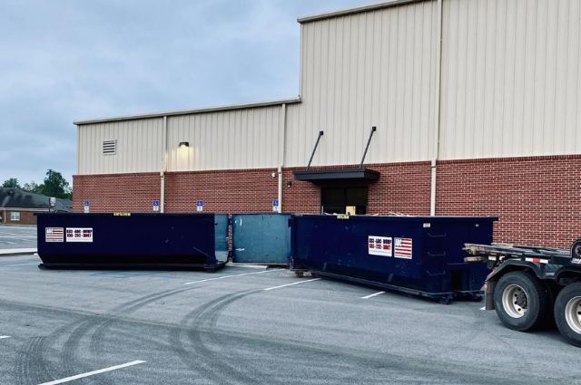 Commercial roll-off dumpsters from American Dumpster Company at a business site