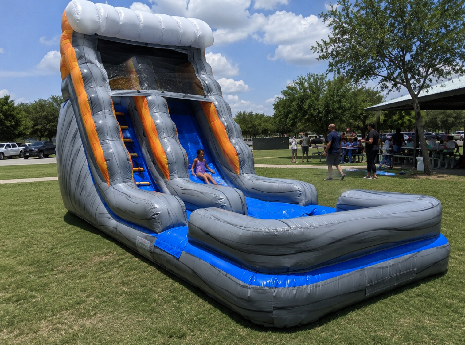 Gray and blue inflatable water slide set up for a park party in Grand Prairie, Texas.