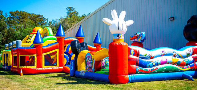 Colorful inflatable bounce houses and slides set up for a children's party or festival