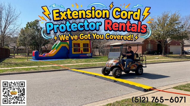 A neighborhood scene with a cord protector crossing the street with a golf cart rolling over it.