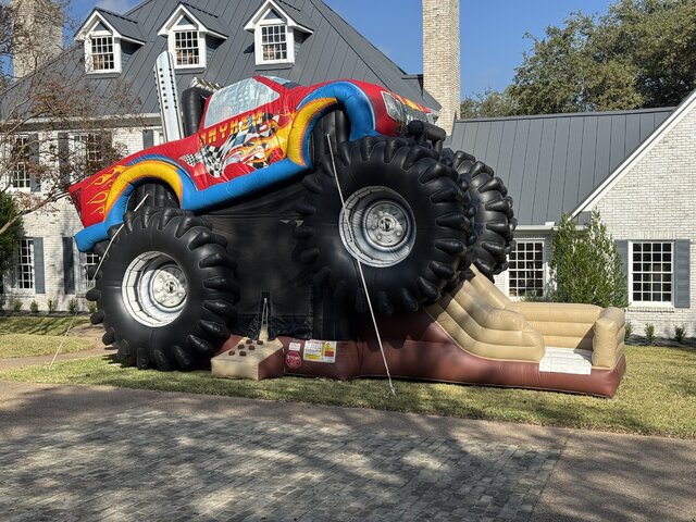 Monster Truck Bounce/Slide Combo setup in a front yard of an Austin Texas house.