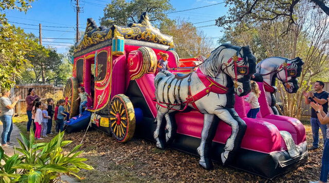 Princess Carriage Combo setup outdoors with kids playing and parents watching in Austin Texas.
