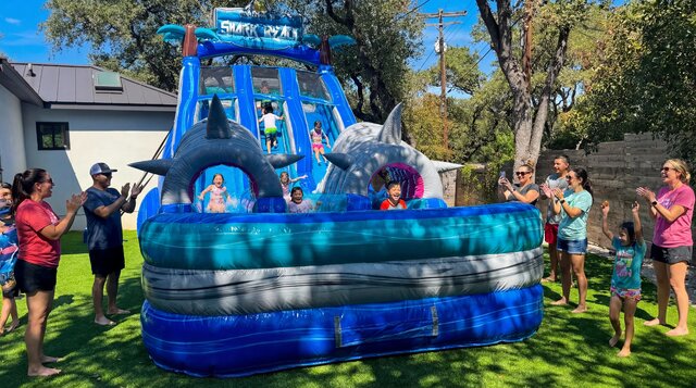 Shark Beach Dry Slide rental in Austin Texas in a front yard from Austin Bounce House Rentals™