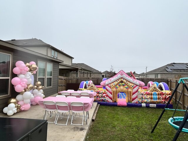 Girls birthday party with Candyland themed bounce house rental in Greater Austin - Jump Around Party Rentals