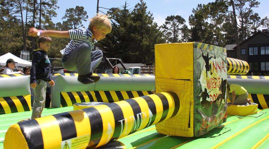 Children having fun on a mechanical ride by Jump Around Party Rentals Children having fun on a mechanical ride by Jump Around Party Rentals