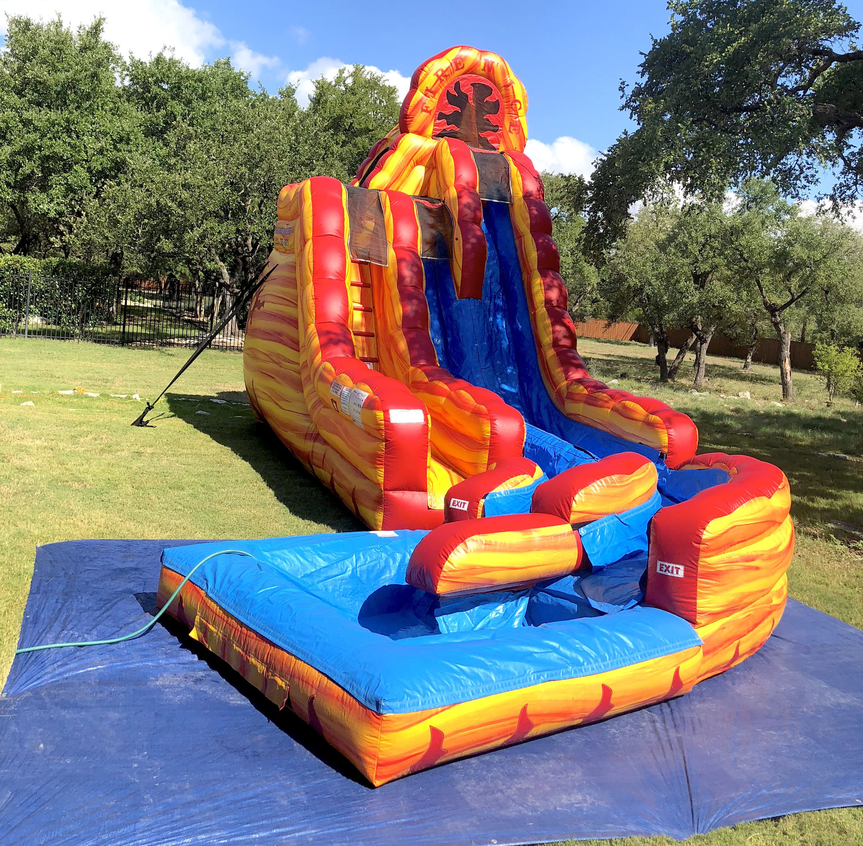 Super Water Slide setup in backyard on grass