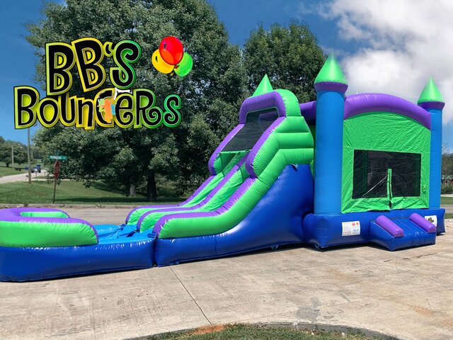Green and purple bounce house with dual lane slide