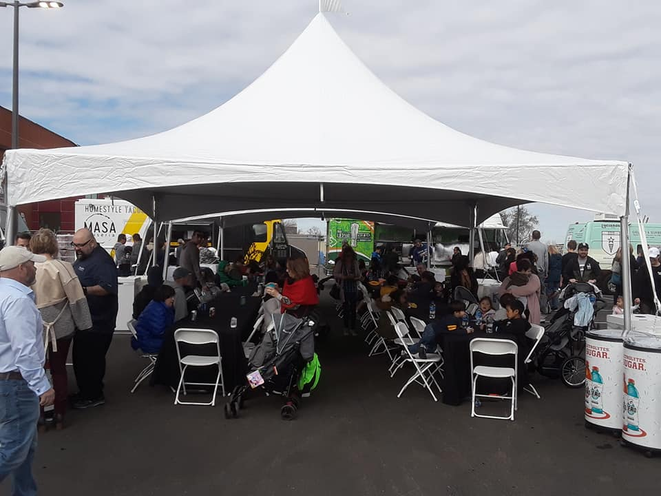 20x20 High Peak Tent set up with round tables and chairs for a Sacramento event