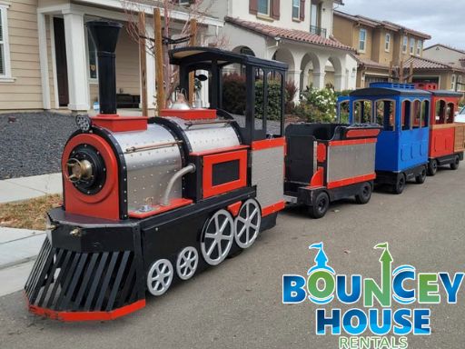 Trackless train rental for corporate events in Sacramento from Bouncey House Rentals carrying guests around a company picnic venue