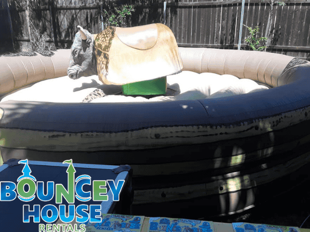 Mechanical bull rentals in Sacramento CA from Bouncey House Rentals showing a mechanical bull setup in a backyard