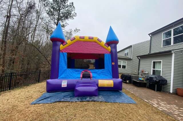 Colorful toddler bounce house with castle towers from Big Bounce Party Rentals