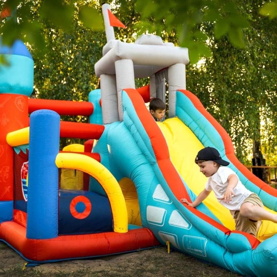Kids sliding on a Big Sky Bounce inflatable bounce house combo
