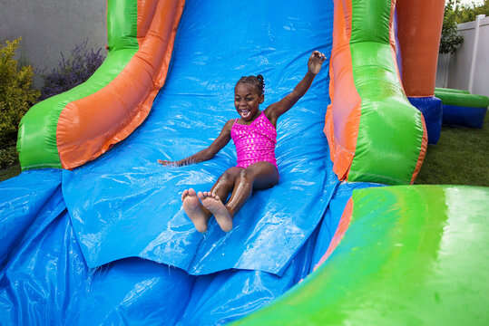 Girl sliding down water slide