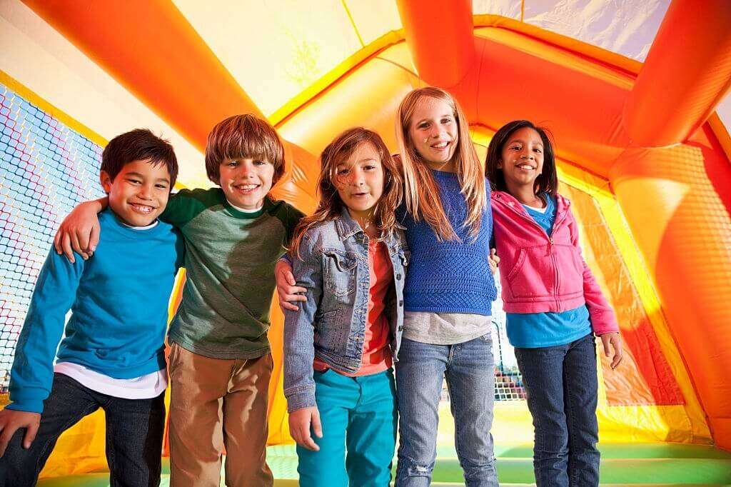 Kids smiling inside bounce house