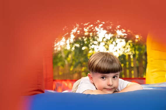 Child resting inside inflatable bounce house