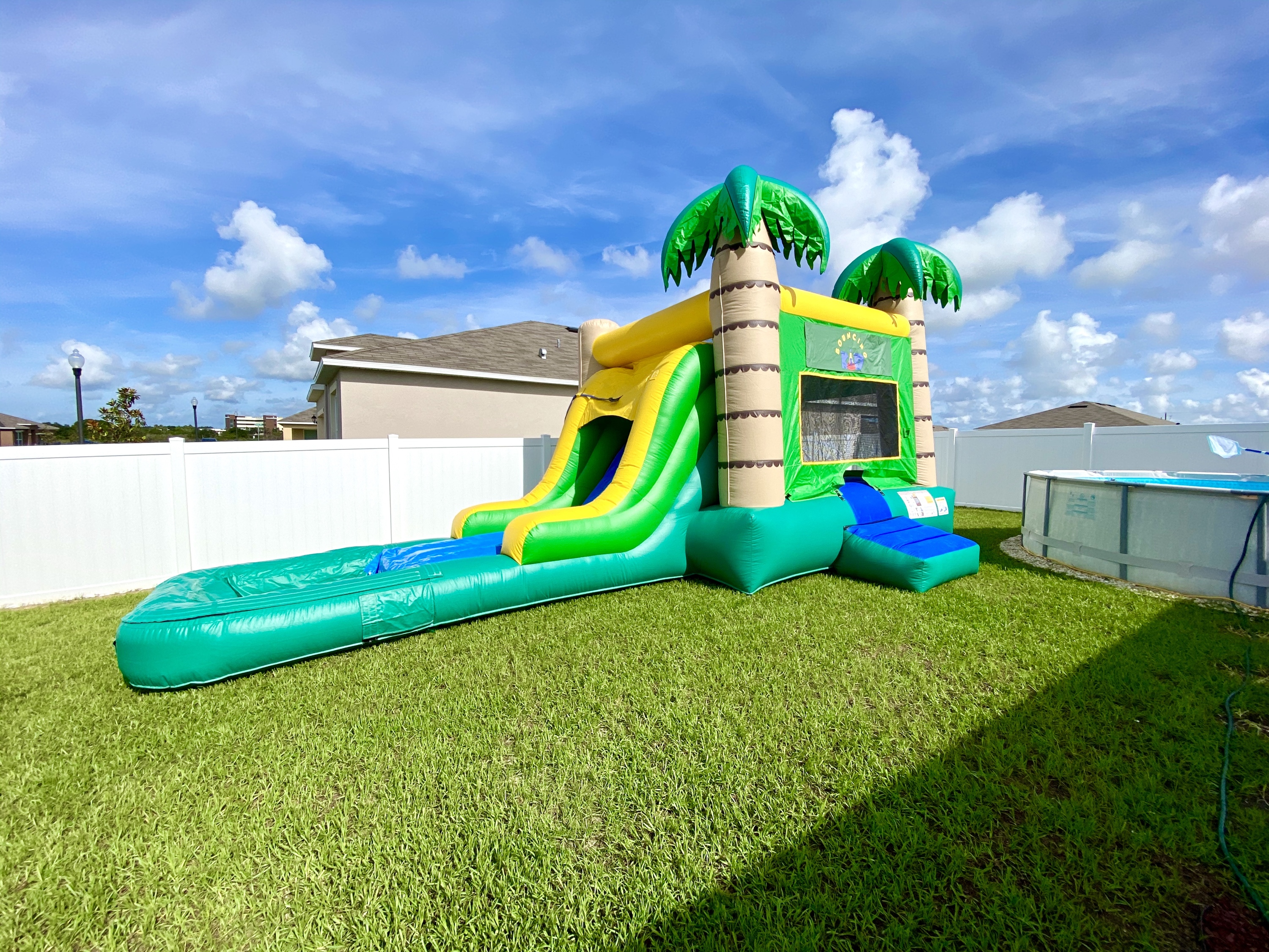 tropical-combo-waterslide-bounce-house-waterslide-rental-bouncing-kid