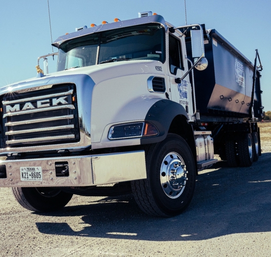 Blue Giant Dumpsters commercial truck with attached dumpster bin.